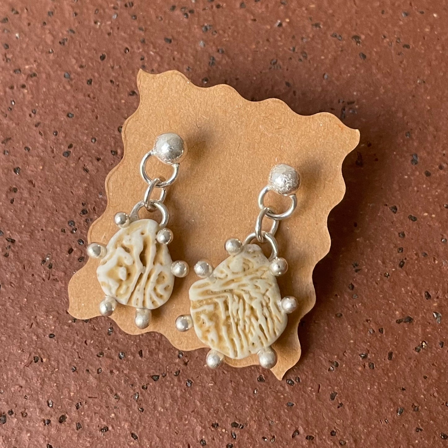 shell dangle studs